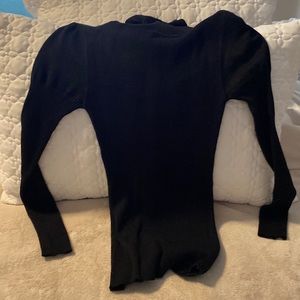 Black turtleneck with shoulder pouf